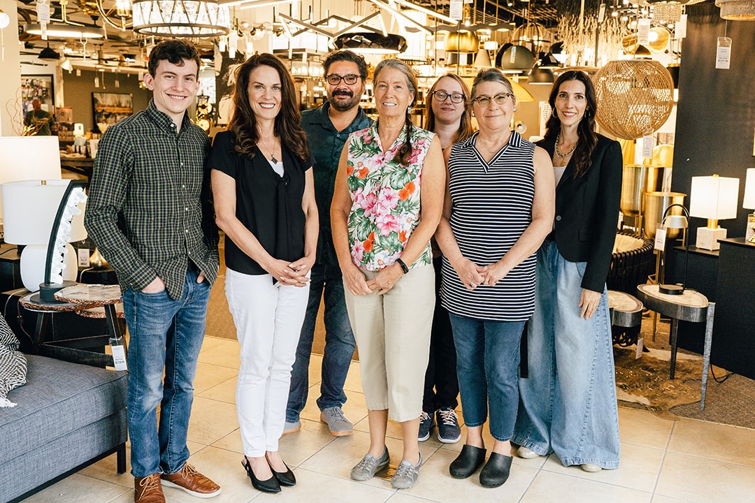 Team of commercial lighting experts stand in lighting showroom